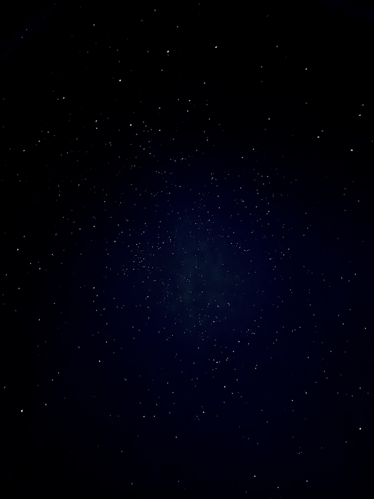 Stars scattered across a deep blue night sky
